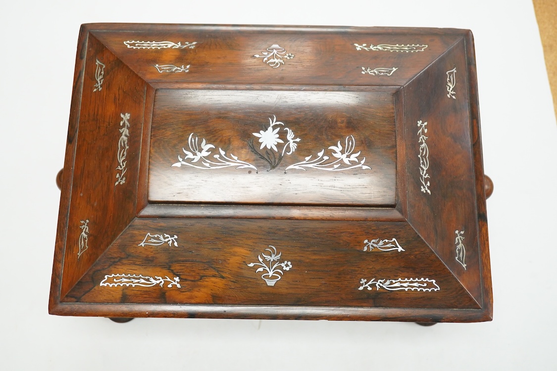 A Victorian mother of pearl inlaid rosewood sewing box and contents including a silver thimble and carved bone thread reels, 33cm wide